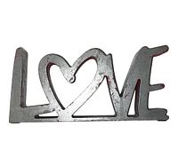 Front facing view of silver metal LOVE sculpture art showing the distinctive heart-shaped O and three-dimensional structure.
