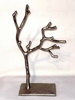 Silver-tone metal jewelry tree sculpture showing front and side views on white background.