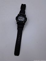 Front view of black Casio G-Shock digital wristwatch showing full strap and watch face.