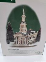 Photo of box artwork showing the mini church with snow and greenery, confirming the identity as Dickens Village St. Martin's in the Fields Church collectible
