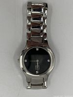Front view of ESQ Swiss wristwatch, showing black dial with diamond-shaped hour markers and stainless steel bracelet.