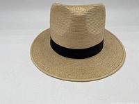 Front view of the vintage handcrafted Guatemalan palm leaf hat showing the woven texture and black band.