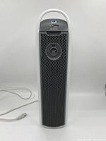 Full front view of Sunbeam tower air purifier showing white and grey body and power cord.