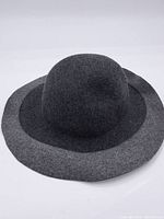 Front view of the dark gray wool felt hat showing wide brim and rounded crown