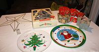 Overall lot showing star tree topper, box of Shiny-Brite glass ornaments, two plastic Christmas platters, and decorative boxes