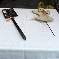 Two Halloween outdoor stake signs on white cloth background, showing full length and detail of stakes.