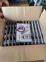 Open cardboard box showing multiple blister packs of 1997 Pepsi Golden Wheel toy cars arranged vertically inside, with visible front packaging including Pepsi logo and car model designs.