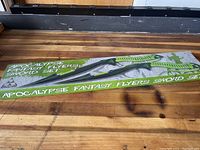 Box of Apocalypse Fantasy Flyers Sword Set containing two swords with green handles and black sheath.