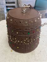 Side view of vintage brown hanging lamp with colorful glass beads and metal chain.