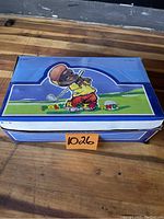 Closed blue box with Poly-Porterland branding featuring a golfing mouse character on lid, holding golf club, containing 24 figurines