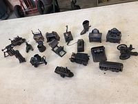 Full overview of 15 metal miniature pencil sharpeners shaped as historic and vintage objects.
