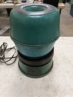 Multiple angles of green electric rock tumbler with black rotating base and attached power cord, showing overall condition and detail.