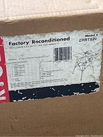 Box label showing specifications and reconditioned status of Ryobi table saw model ZRRTS20.
