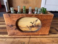 Wooden crate showing a rustic duck hunting painting on the front panel.