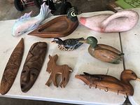 Full display of all vintage wooden decor items on a white table showing variety and condition