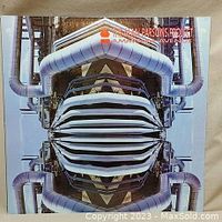 Front cover of vinyl record showing artistic image of industrial pipes with title 'The Alan Parsons Project Ammonia Avenue'