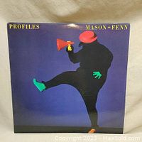 Front cover of vinyl record album 'Profiles' by Mason + Fenn featuring colorful silhouette artwork against a blue background.