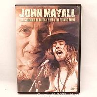 Front cover of the John Mayall DVD showing his portrait and a live performance photo.