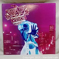 Front cover of War Child vinyl album with purple cityscape and figure.