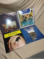 Four classical music vinyl LP albums showing front covers: Mozart, Maurice Ravel, Delius, and Pan Pipes Tour titles.
