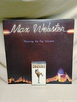 Photo of Max Webster vinyl album cover "Mutiny Up My Sleeve" with a cassette tape placed in front on top of it.