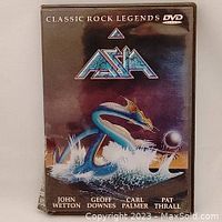 Front cover of Asia Classic Rock Legends DVD showing artwork with sea serpent and band name with band member names.