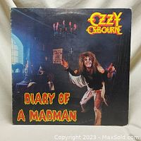 Front cover of Ozzy Osbourne 'Diary of a Madman' vinyl album showing the iconic artwork with Ozzy in theatrical pose and title in bold yellow and red letters.