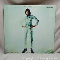 Front cover of the vinyl album "Who Came First" showing Pete Townshend standing with hands on hips in white jumpsuit.