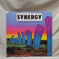 Front cover of Synergy vinyl album with colorful abstract futuristic artwork and title text
