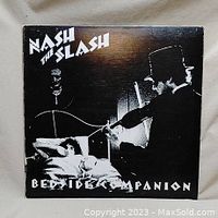 Front cover of Nash the Slash vinyl LP titled 'Bedside Companion' showing black and white artwork with violin player and reclining figure.
