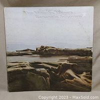 Front cover of The Moody Blues Seventh Sojourn vinyl album showing landscape artwork and album title.