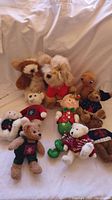 Full group of plush toys including E.T. style plush, Boyds Bears, and Sandy the dog.