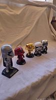 Side view of five Funko Pop Star Wars figures in a row showing different colors and finishes