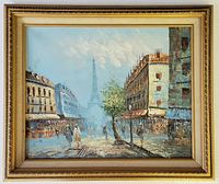 Framed oil painting showing Paris street scene with buildings, tree, pedestrians, and Eiffel Tower in the background