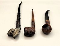 Photo showing three pipes side by side on white background with visible details and finishes