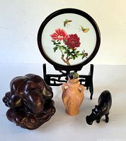 Image showing all four items: rosewood screen, terracotta container, resin monk sculpture, black resin animal figurine