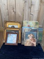 Overview of all mixed artwork items including framed shadowbox, multiple canvas prints, and gold frames.