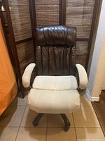 Front view of brown high back office chair with white seat and arm covers, showing cushioned padded surfaces and upholstery.