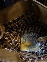 Interior of the Tignanelli brown handbag showing branded fabric lining and label.