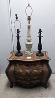 Wicker trunk with three lamp bases on top, showing shape and design