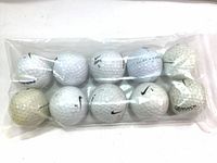 Pack of ten used golf balls in a clear plastic bag, showing wear and discoloration.