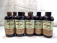 Front view of eight Hoppe's Bench Rest 9 Copper Solvent bottles with visible labels and caps.