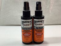 Two new 120ml spray bottles of Hoppe's Elite Gun Cleaner with orange and black labeling, front view.