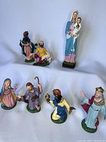 Full set of seven vintage Italian nativity figurines, showing variety of characters including Mary and baby Jesus, shepherds, and wise men.