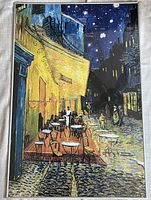 Full view of the framed Van Gogh Cafe Terrace poster showing the night scene with cafe tables, starry sky, and street.