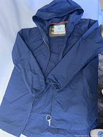 Navy blue Herschel hooded jacket front view with zipper closed