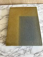 Front view of green slipcase with fading on one side.