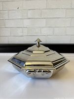 Top-angle view of octagonal covered server highlighting the lid and finial knob detail.