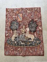 Front view of vintage wall tapestry showing The Lady with the Unicorn scene of lady, unicorn, lion, and lush floral background