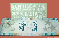 Two beach themed wall hangings placed with the vertical one on top showing seashell and starfish designs with phrase.